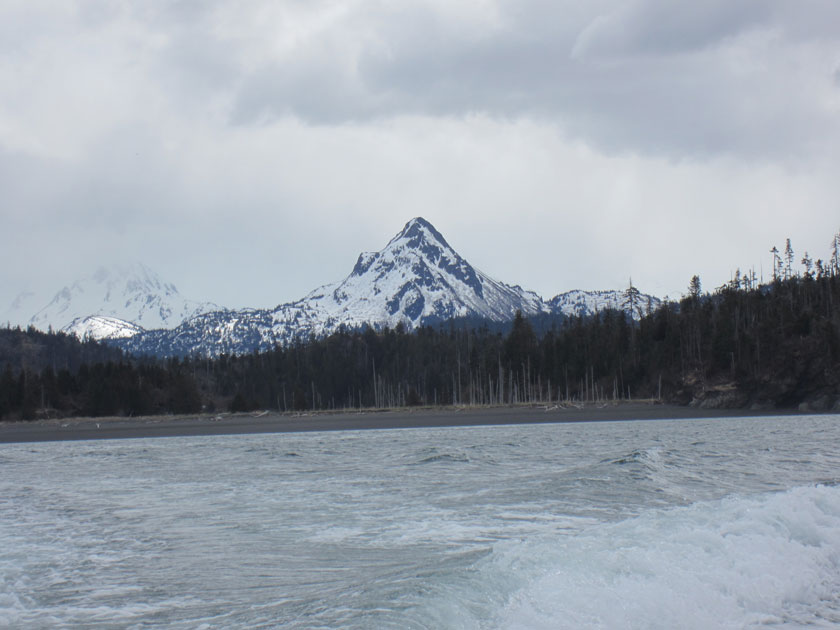 snow-covered mountain peak along the ocean