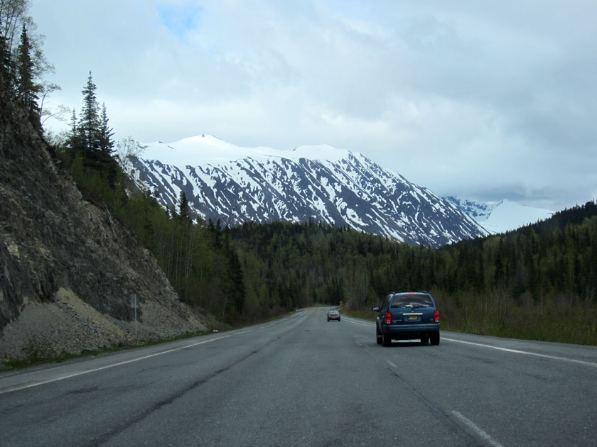 cars on the highway with a mountain
