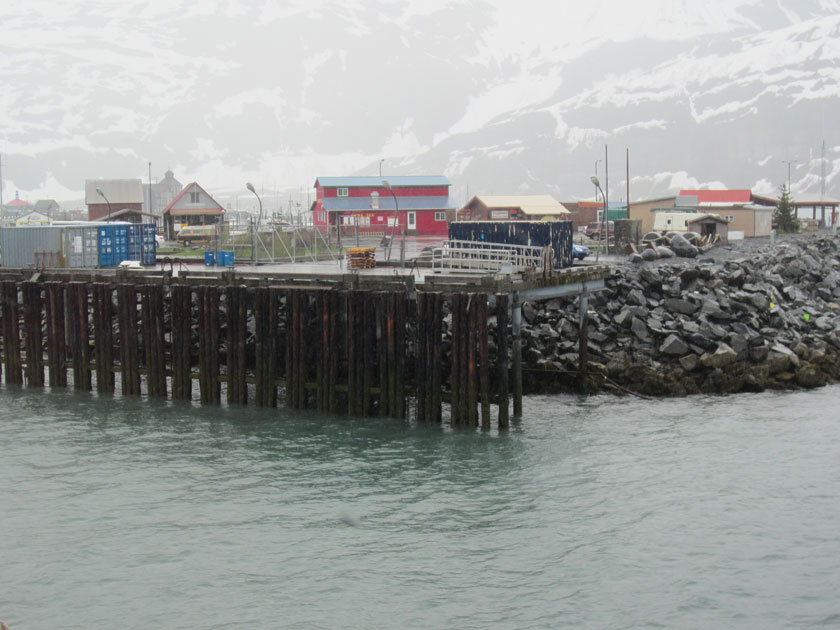 a wooden pier and rocky sea break