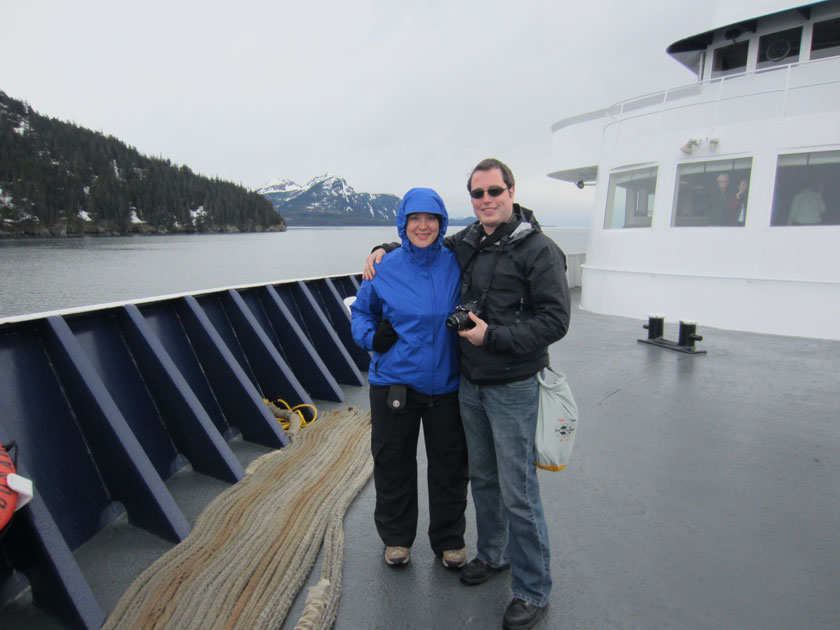 a couple standing on a large ferry boat
