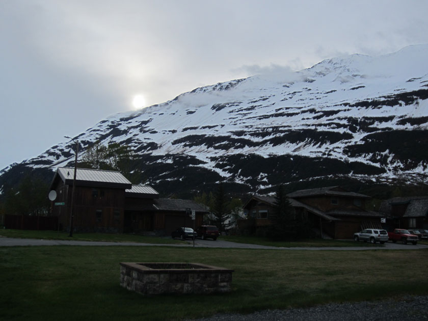 sun setting over a snow-covered mountain