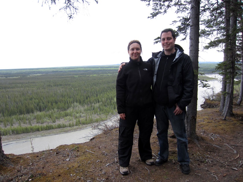 couple standing in front of a river valley
