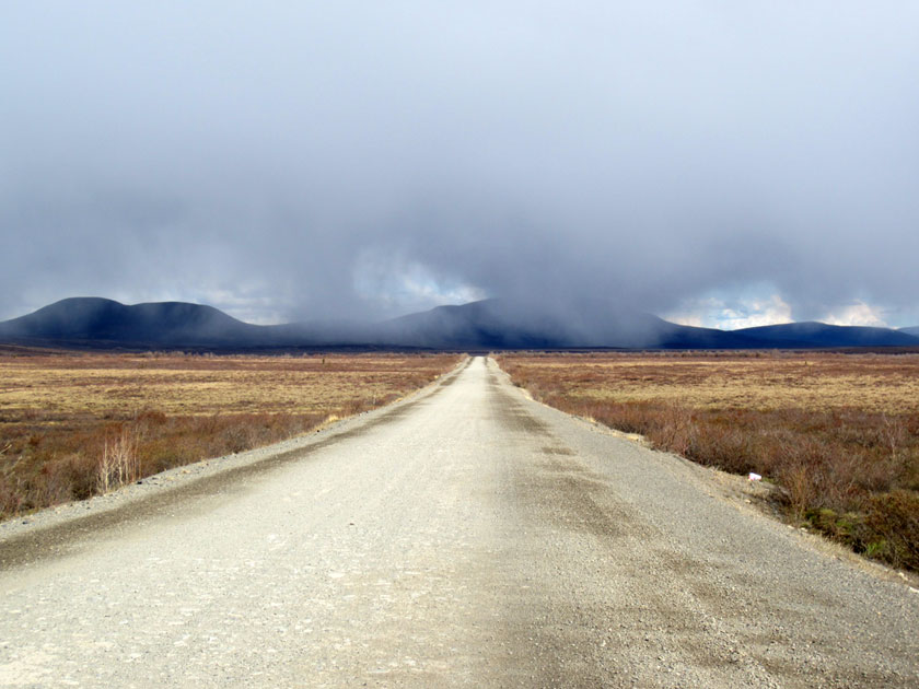 dirt road leading into fog
