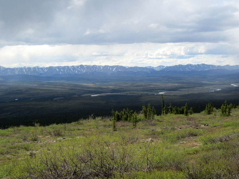 river valley with mountains in the distance