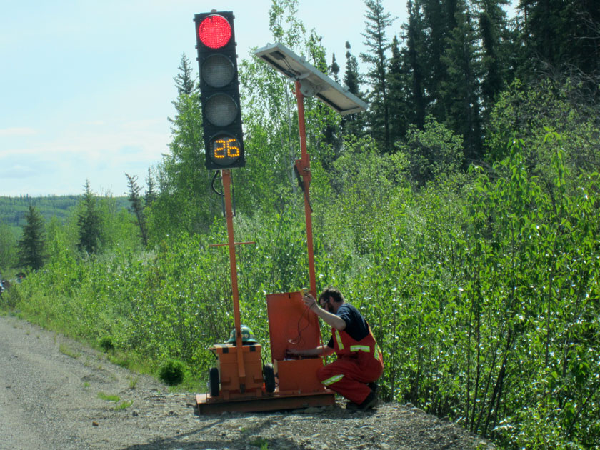 construction worker adjusting an electronic sign
