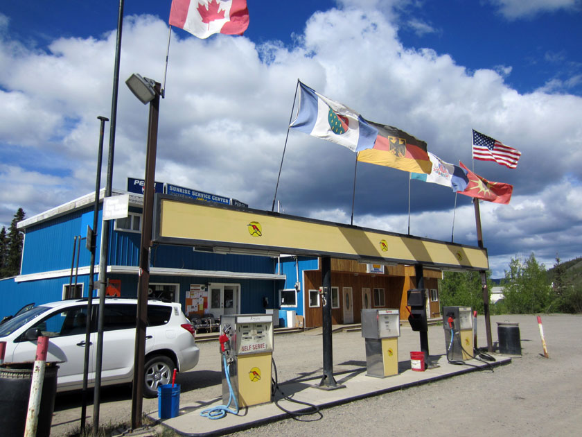 gas bar with flags flying above it