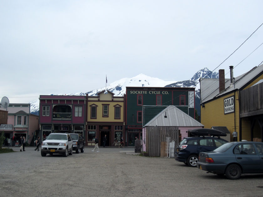 view down an alley towards building with false fronts