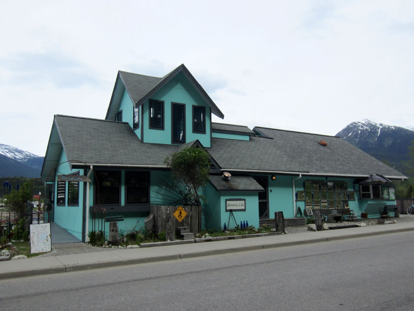 teal-colored building with a sign reading 'Stowaway Cafe'