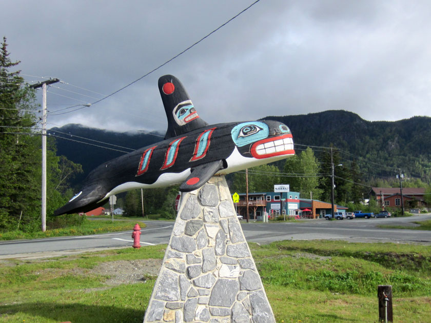 carving of an orca whale on a stone pedestal