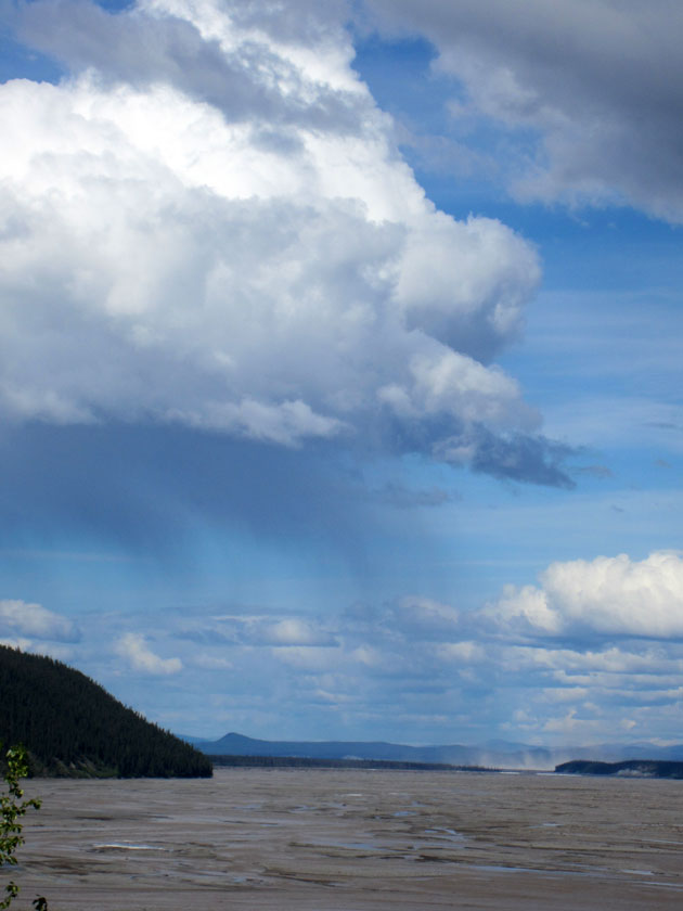 rain clouds above a river bed