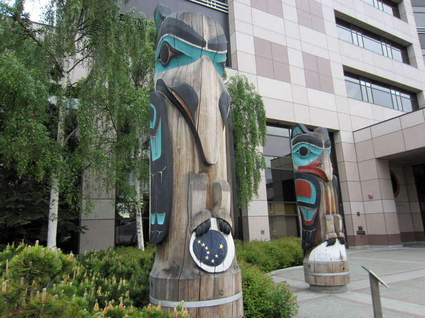 two large wooden totems, one of a raven and the other of an eagle