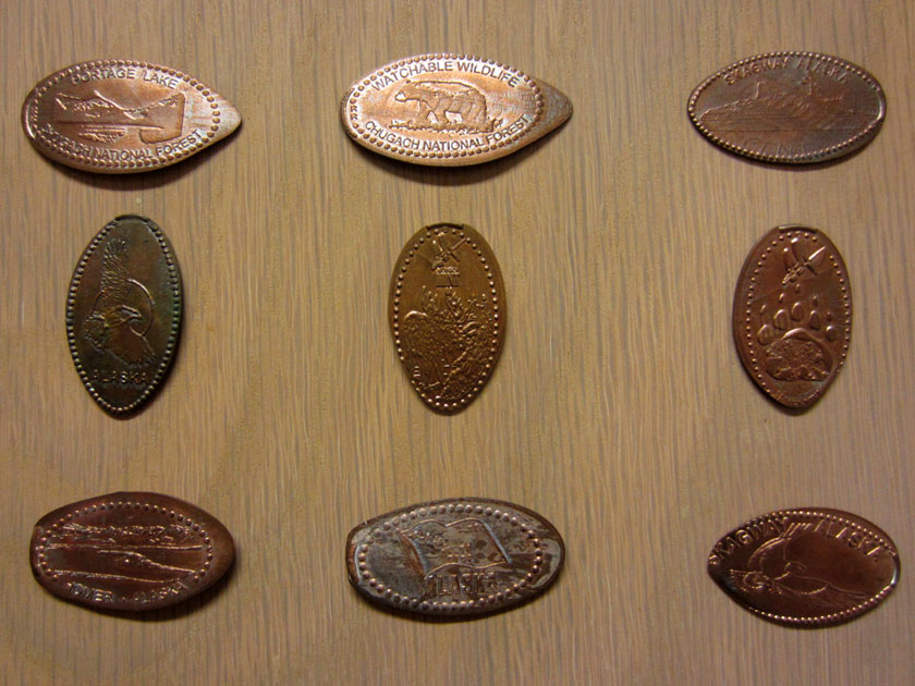 several smashed pennies with various designs from Alaska
