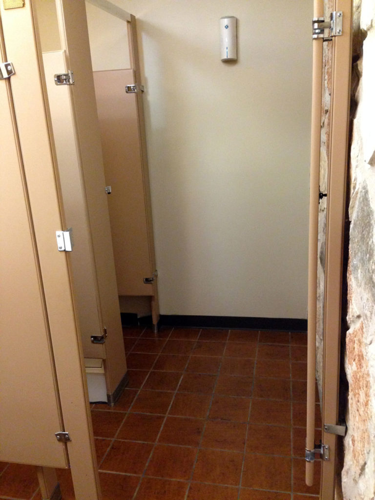 photo of a double bathroom stall with an outer door to close off the space for a wheelchair user