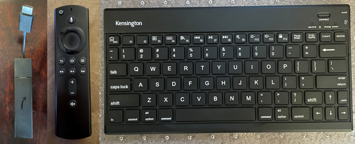 Fire TV stick and remote next to a Bluetooth keyboard