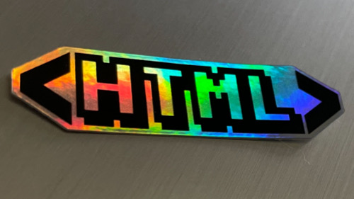 HTML sticker reflecting a rainbow gradient from its holographic background