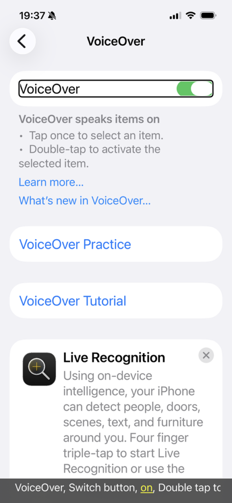 screenshot of the iOS VoiceOver screen with the VoiceOver toggle switched on and the caption panel displayed at the bottom announcing that VoiceOver is on.
